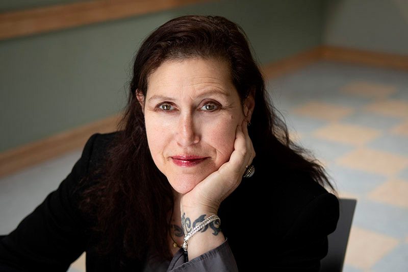 Woman in black jacket, serene gaze
